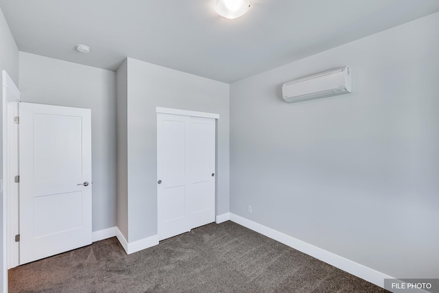 5871 S Sherri Lea Rd, Spokane, WA 99224 - unfurnished bedroom featuring a closet, an AC wall unit, baseboards, and dark colored carpet