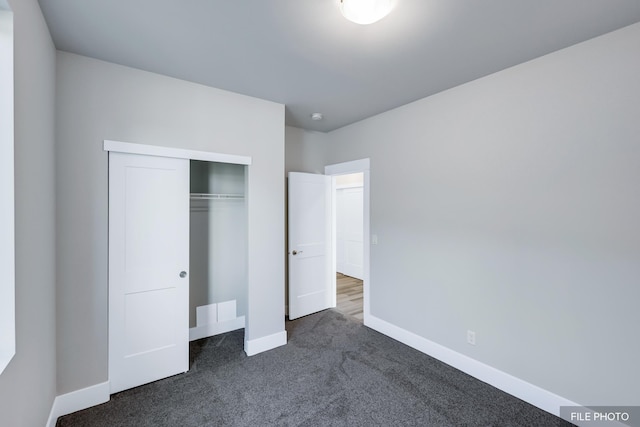 5871 S Sherri Lea Rd, Spokane, WA 99224 - unfurnished bedroom featuring a closet, dark carpet, and baseboards