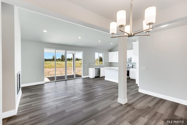 5871 S Sherri Lea Rd, Spokane, WA 99224 - unfurnished living room with dark wood-style floors, baseboards, recessed lighting, vaulted ceiling, and a chandelier
