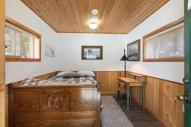 bedroom featuring wood ceiling, wood walls, and dark wood-type flooring