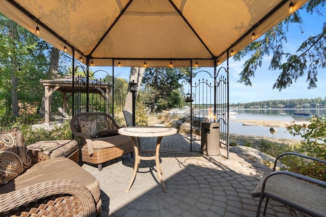 view of patio / terrace with a gazebo and a water view