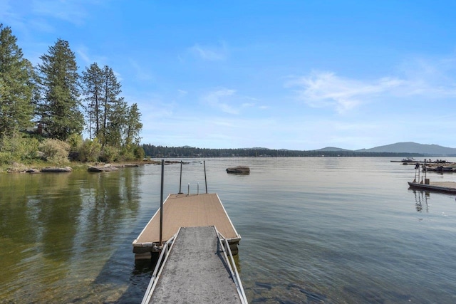 dock area featuring a water and mountain view