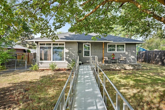 rear view of property with a lawn