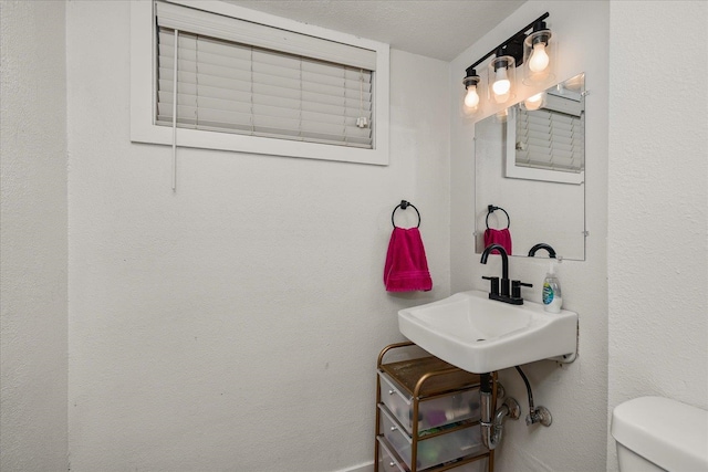 bathroom with a textured ceiling and toilet