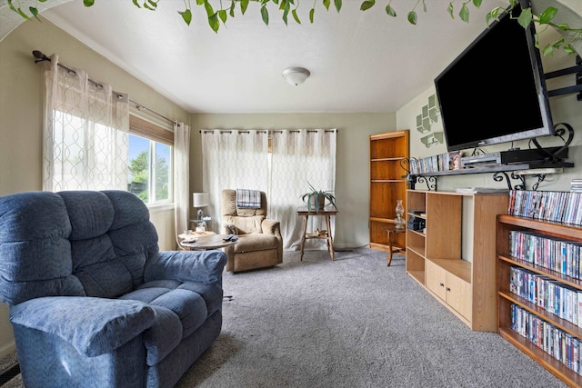 carpeted living room featuring crown molding