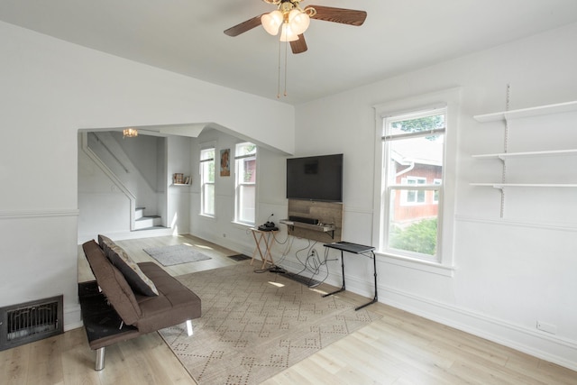 unfurnished living room with light hardwood / wood-style floors and ceiling fan