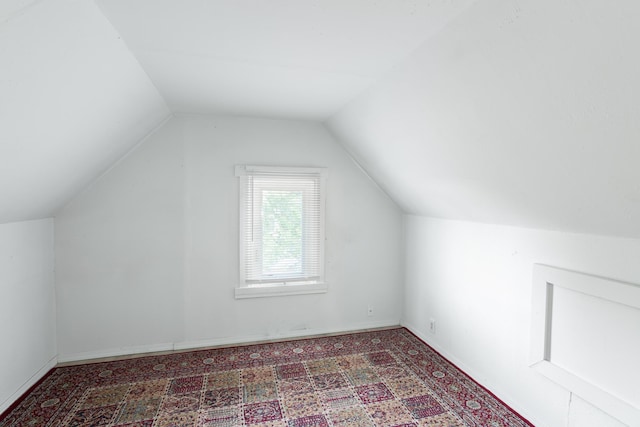 additional living space featuring vaulted ceiling