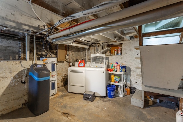 basement featuring electric water heater and independent washer and dryer