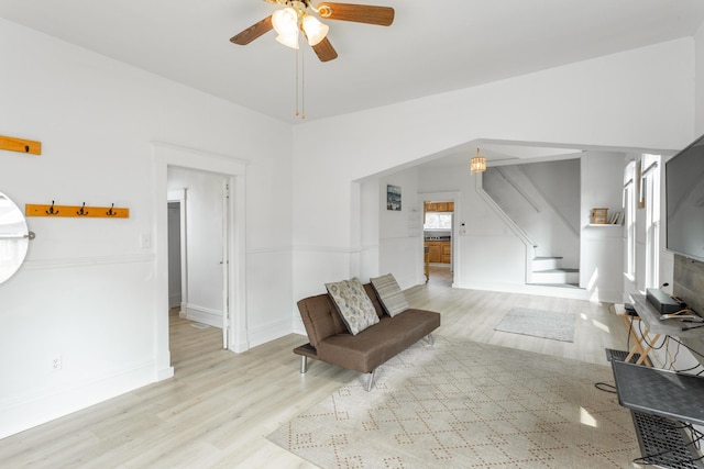 living room featuring ceiling fan and light hardwood / wood-style floors