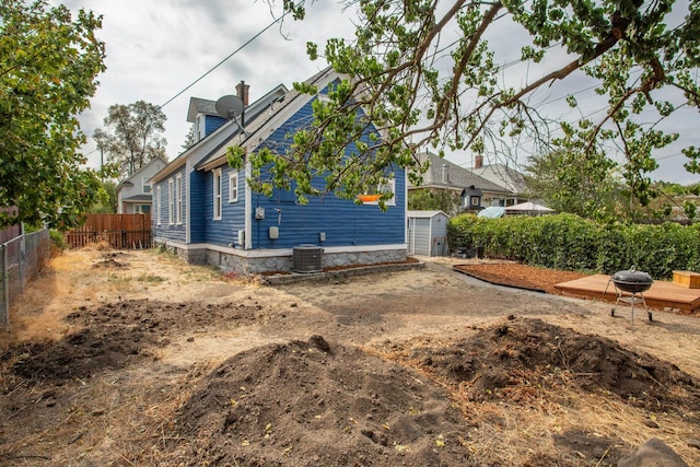 view of property exterior featuring a wooden deck and cooling unit