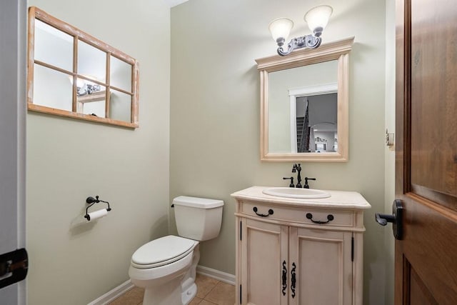 bathroom featuring vanity, toilet, and tile patterned flooring