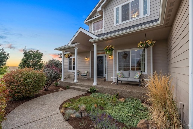 exterior entry at dusk featuring outdoor lounge area