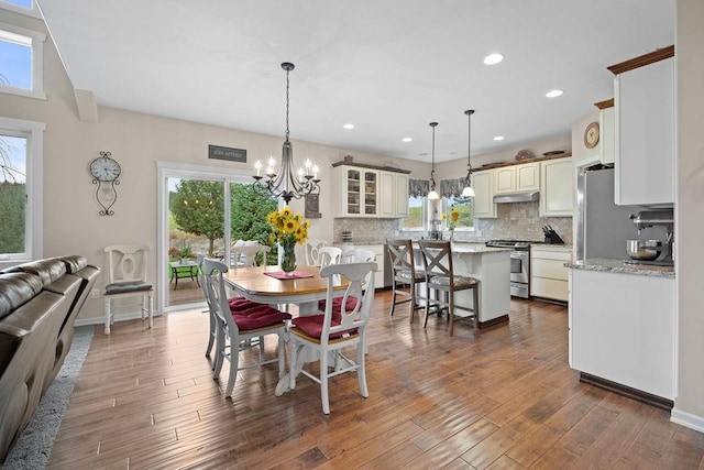 dining area with a wealth of natural light and dark hardwood / wood-style floors