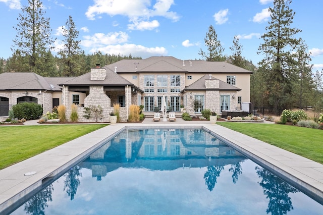 back of property featuring a yard and a patio area