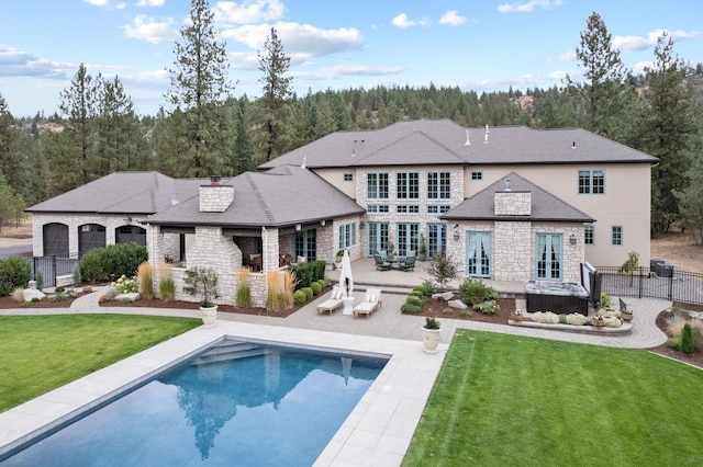 rear view of house featuring a lawn and a patio