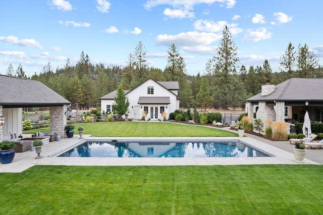 view of swimming pool with a yard and a patio area