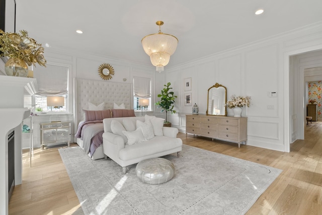 bedroom with crown molding and light hardwood / wood-style flooring