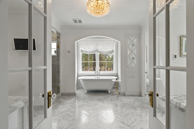 bathroom with plus walk in shower, crown molding, french doors, a notable chandelier, and parquet floors