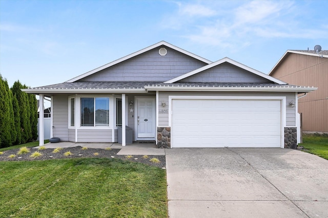 view of front of house featuring a garage and a front lawn