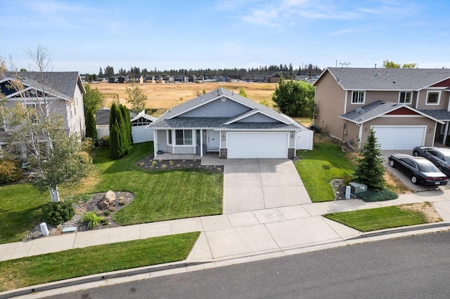 view of front of property with a front yard and a garage