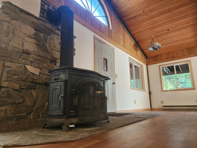 unfurnished living room with high vaulted ceiling, a wood stove, wooden ceiling, wood-type flooring, and a baseboard radiator