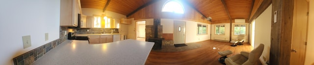 kitchen with wood ceiling, vaulted ceiling, dishwasher, and backsplash