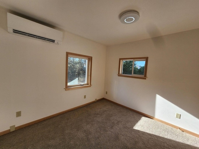 carpeted spare room featuring an AC wall unit