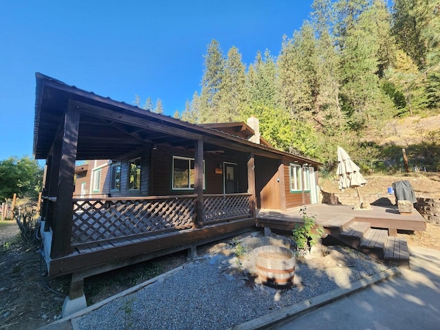 rear view of property with a wooden deck