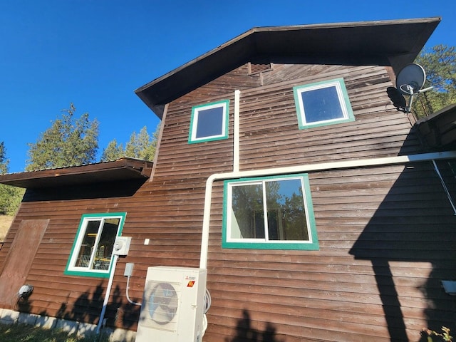 view of side of home featuring ac unit