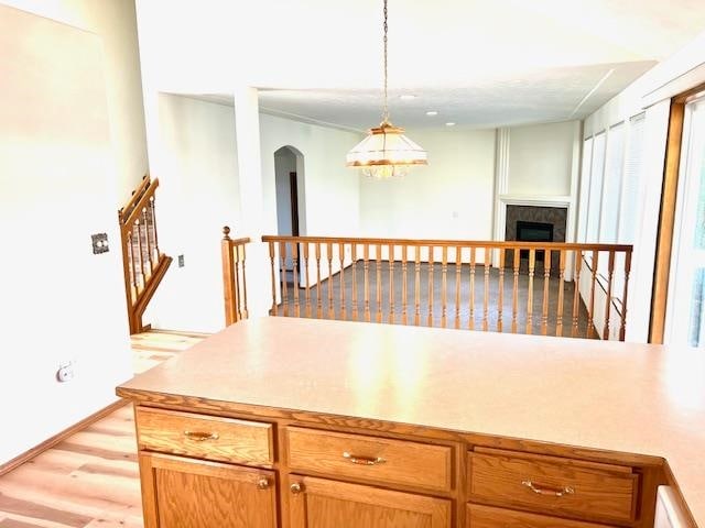 kitchen with pendant lighting and light hardwood / wood-style floors