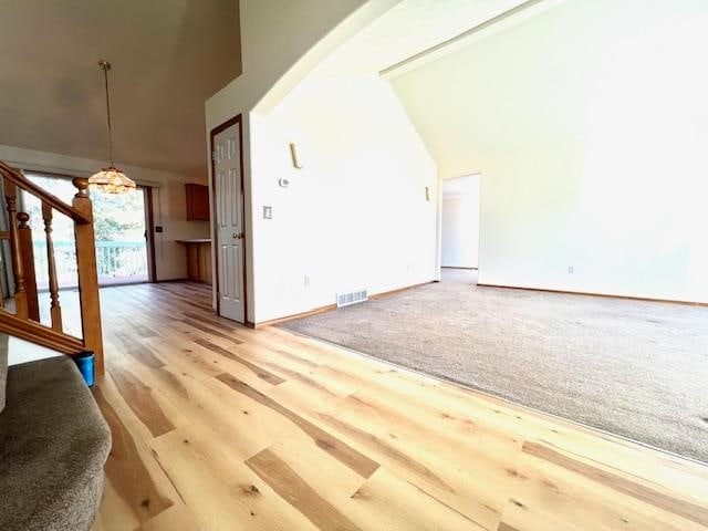 bonus room featuring wood-type flooring and high vaulted ceiling