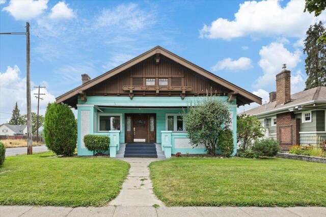 bungalow with a porch and a front yard