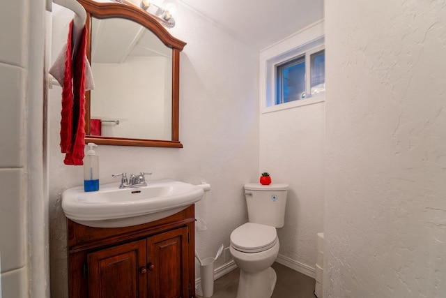 bathroom with vanity, tile patterned flooring, and toilet