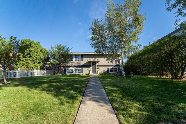 raised ranch featuring a front yard