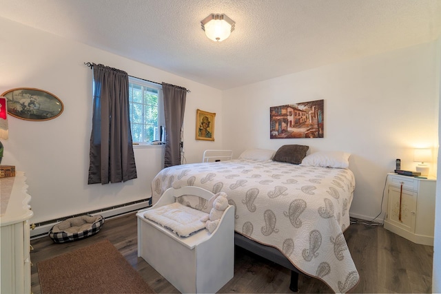 bedroom featuring a textured ceiling, baseboard heating, and dark hardwood / wood-style floors