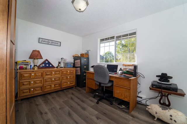 office area with a textured ceiling and dark hardwood / wood-style flooring