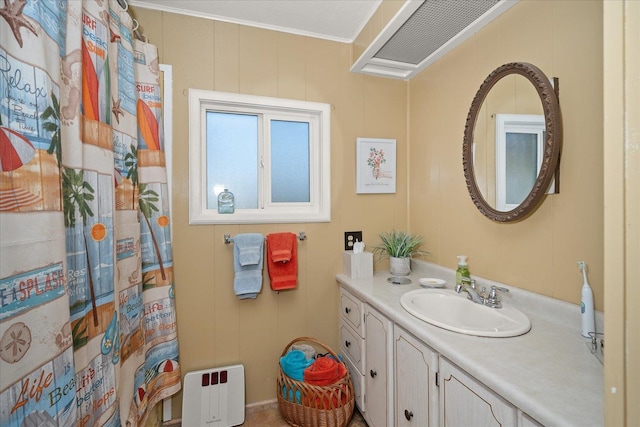 bathroom with ornamental molding and vanity