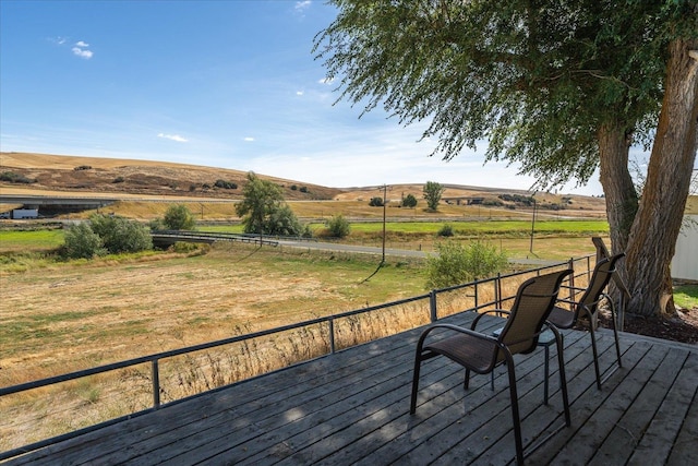 wooden deck featuring a rural view