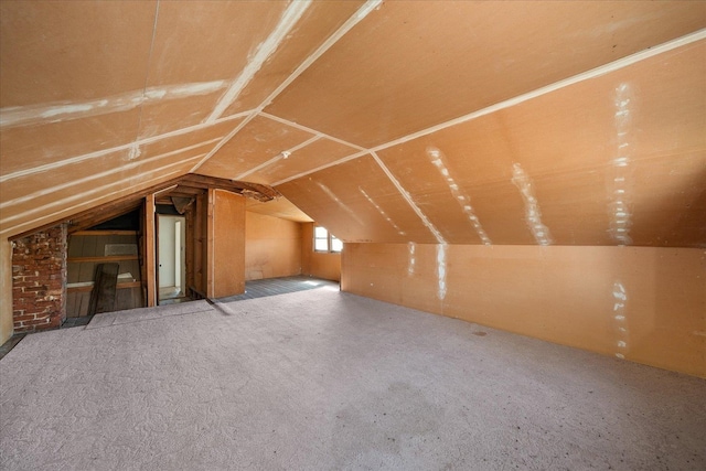 additional living space featuring vaulted ceiling