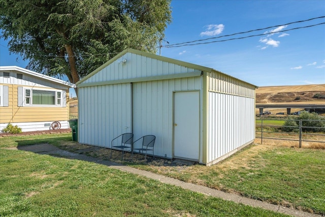 view of outdoor structure featuring a lawn