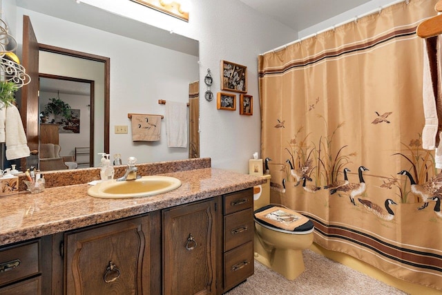 bathroom with toilet, curtained shower, and vanity