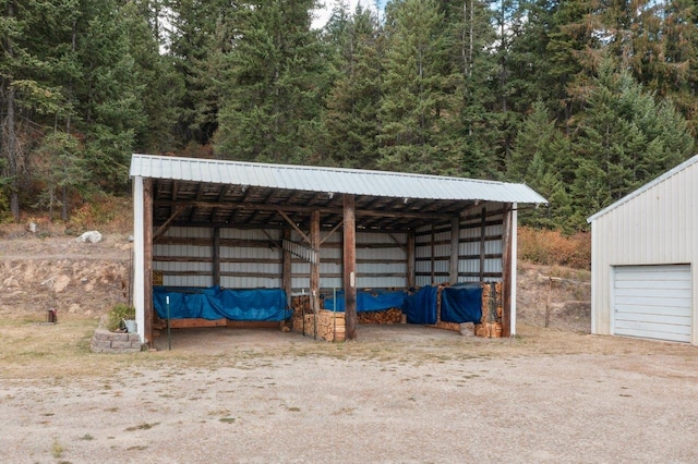 view of pole building with a garage and driveway