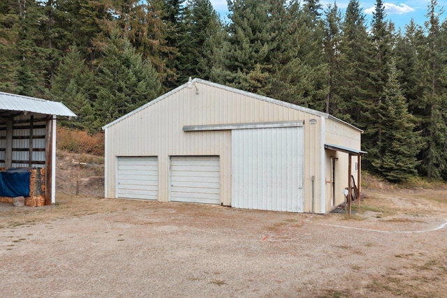 detached garage with a forest view