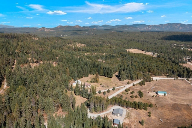 aerial view featuring a view of trees and a mountain view