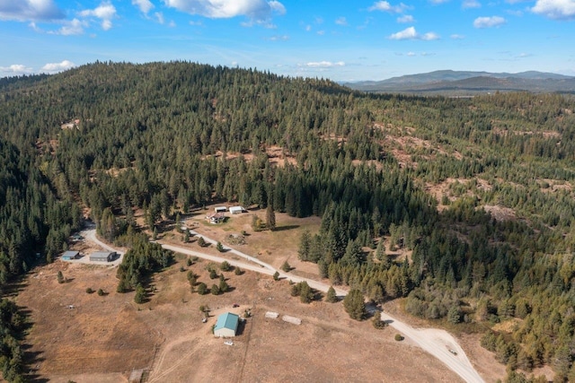 aerial view featuring a mountain view and a forest view