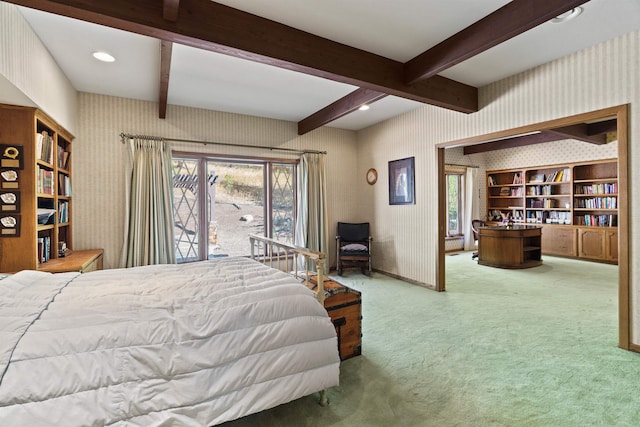 carpeted bedroom featuring beamed ceiling