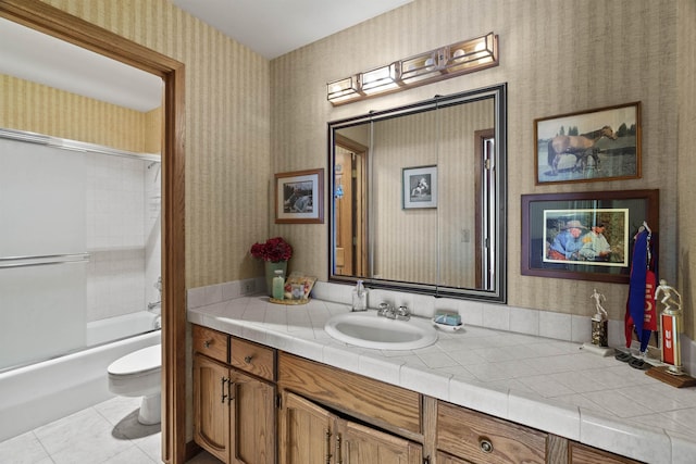 3206 W Long Prairie Rd, Valley, WA 99181 - bathroom featuring wallpapered walls, toilet, vanity, shower / bathtub combination, and tile patterned flooring