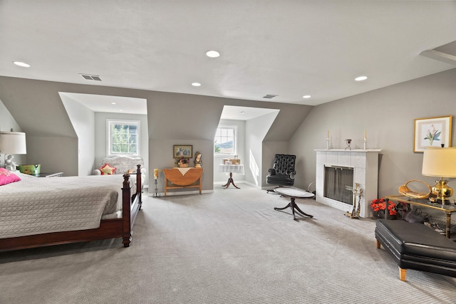 bedroom with light colored carpet and vaulted ceiling