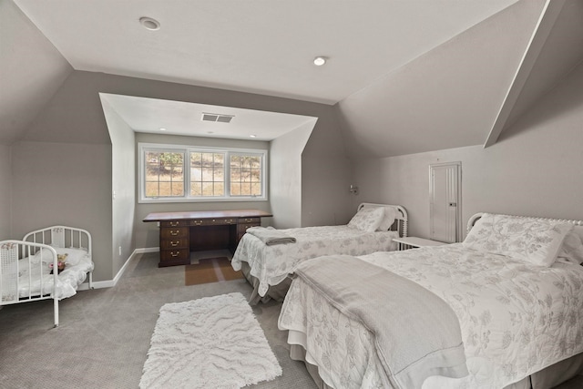 carpeted bedroom with lofted ceiling