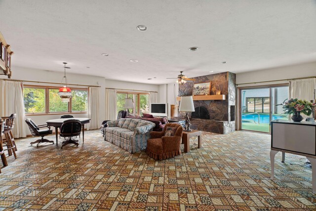 3206 W Long Prairie Rd, Valley, WA 99181 - living room with a fireplace, a ceiling fan, recessed lighting, and carpet flooring